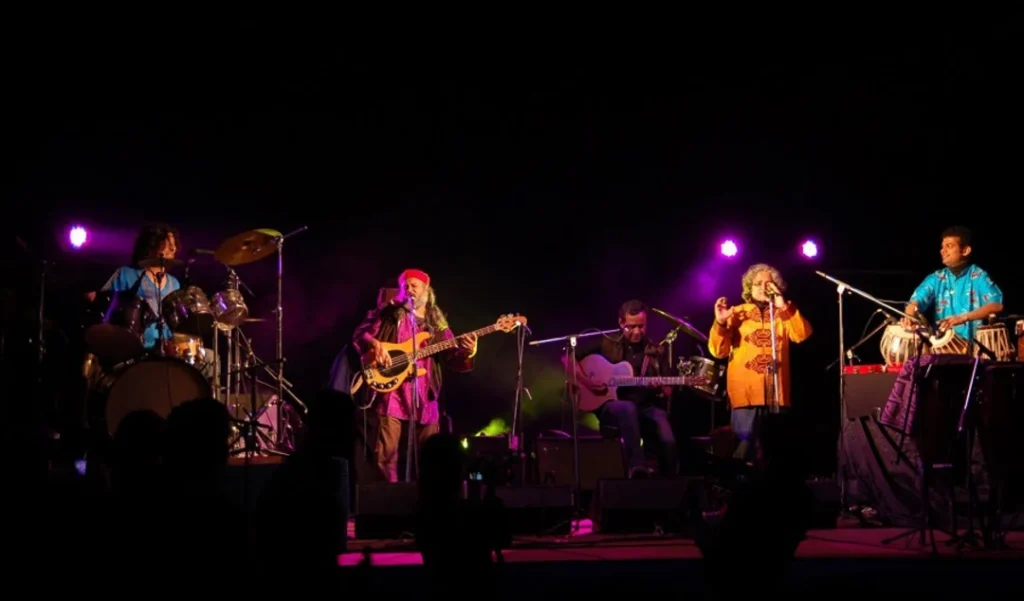Performers on a large concert stage under colourful lights at AFAS Live